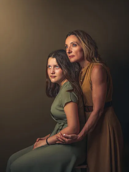 A duplicate of image 96, this stunning painterly portrait captures the deep connection between mother and daughter. The classic lighting and composition elevate the photograph to a work of art, perfect for a family heirloom.