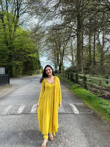 A full-length view of the yellow corset anarkali set, showing its flattering fit and beautiful color. This piece can be customized in any color and size.