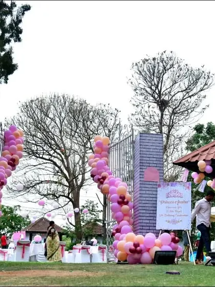 The grand castle gates that served as the entrance to the princess party, decorated with pink balloon garlands.
