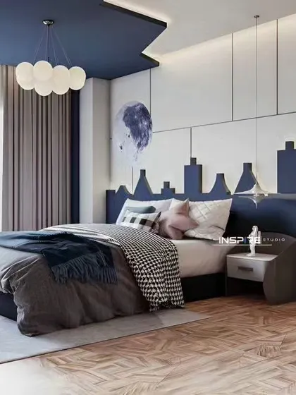 This boy's bedroom has a cool, city-skyline-themed headboard and a modern blue and white color scheme. The house-shaped bookshelf adds a playful touch while offering practical storage.