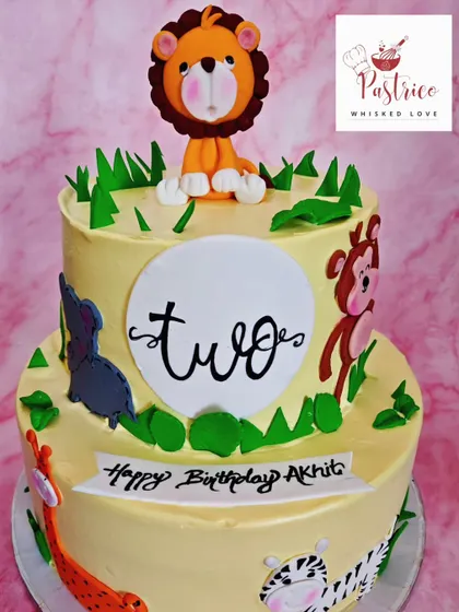 This two-tiered jungle theme cake is filled with friendly fondant animals, perfect for a second birthday party for a little explorer.
