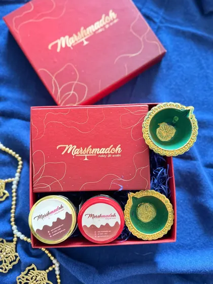 My festive gift boxes are designed to be a joy to receive. This one contains jars of my Honey Almond and Cashew Sea Salt wholewheat cookies, along with traditional diyas.
