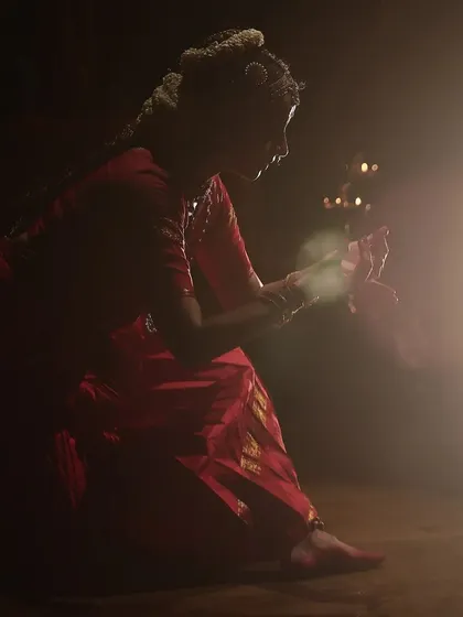 An artistic shot using a single light source to create a halo effect, symbolizing a moment of divine realization for the devotee.