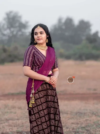A full-length standing shot from my portfolio photoshoot, showcasing the flow of the saree and the overall styling.