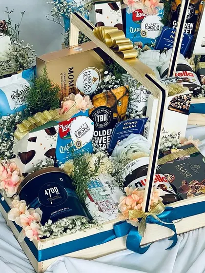 The vibrant colors and textures of the items in this hamper make it an exciting and visually appealing gift to receive.