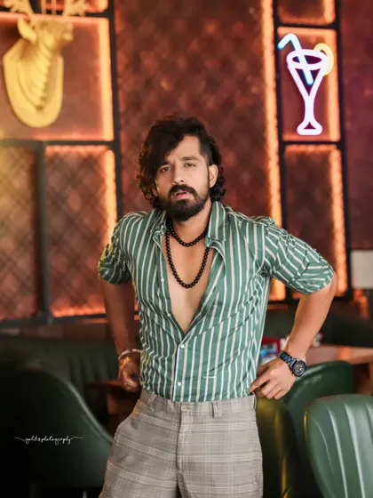 A collection of indoor portraits of an actor in a stylishly casual striped shirt. The moody lighting of the cafe setting adds a cinematic and modern feel, perfect for a character portfolio.