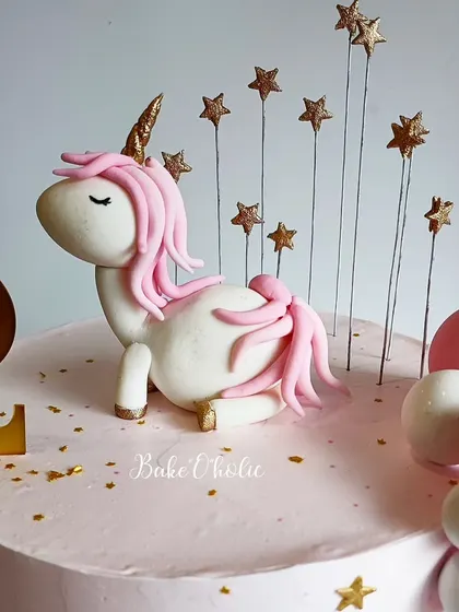 A close-up of the serene, handcrafted unicorn topper. It's a sweet and gentle take on the popular unicorn theme.