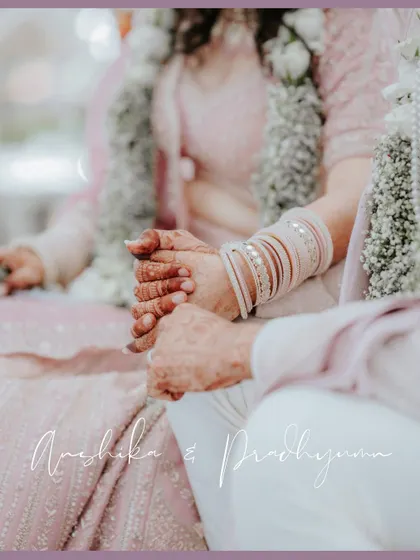 A close-up of the couple's hands, intertwined during the ceremony. This detailed shot, with its soft pastel tones, emphasizes their connection and commitment.