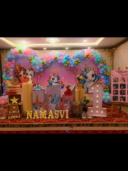 We created a magical unicorn kingdom for Namasvi's first birthday, with a heart-shaped balloon arch and multiple unicorn characters to delight the little guests.