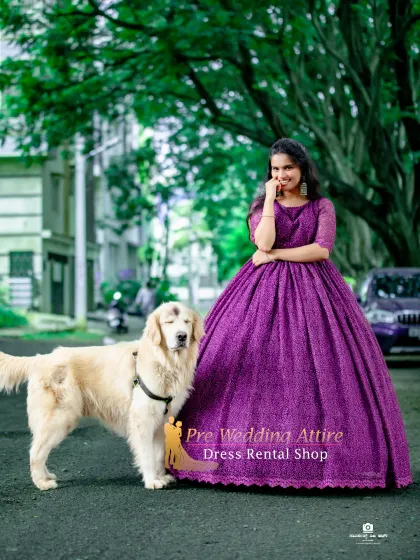 A beautiful purple ball gown with a delicate lace texture. The full skirt creates a classic A-line shape, and the color is both unique and regal. Posing with a pet can add a personal touch to your shoot.