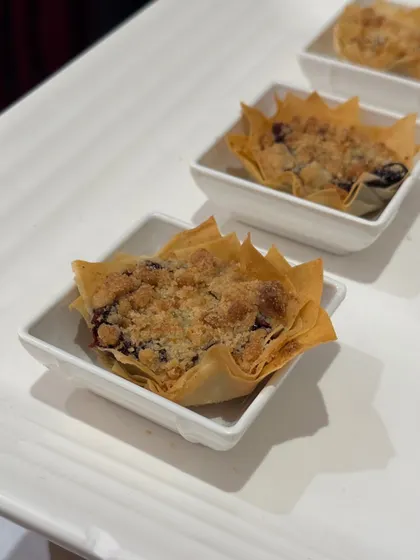 A close-up of our delicate and crispy filo pastry tart, filled with a sweet and crumbly mixture. A perfect bite-sized dessert.