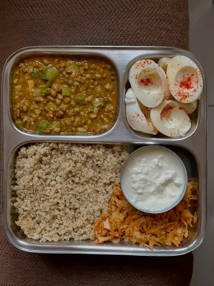 An excellent eggetarian high-protein meal with quinoa, green gram dal, boiled egg whites, sautéed cabbage, and a side of curd.