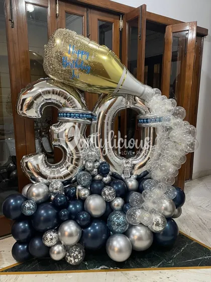 Pop the bubbly. A spectacular 30th birthday balloon arrangement featuring a giant champagne bottle and silver and navy balloons.