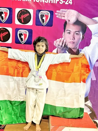 Draped in the Indian flag, our young champion celebrates her victory, a powerful symbol of her dedication and our nation's pride.