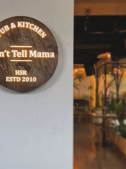 The custom wooden sign for "Don't Tell Mama." We believe small details like signage are crucial for establishing a brand's personality right from the entrance.