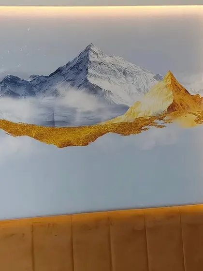 An abstract mountain range with gold leaf accents installed above a headboard. The wallpaper is enhanced by LED strip lighting, which I carefully worked around.