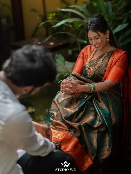 A candid shot of the groom putting on the bride's anklet. It's these quiet, caring moments during the getting-ready process that we love to capture.