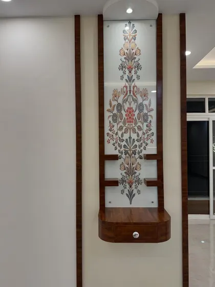 A compact and elegant wall-mounted pooja unit for Milanshu and Geetika's home. The floral patterned glass and wooden frame create a modern yet traditional sacred space.
