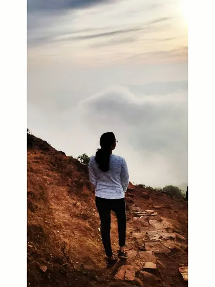 Looking out at the clouds from a mountain path. Taking time to breathe and appreciate the view is essential.