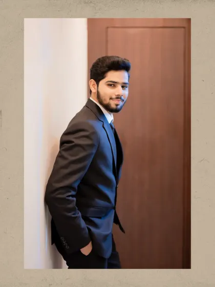 A dapper portrait of the groom-to-be in a classic black suit, looking sharp and ready for his engagement ceremony.