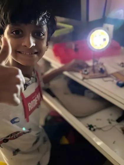 A thumbs-up for a successful project. This student is proud of the light he built and wired himself during our fun and educational summer camp.