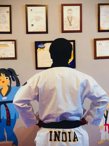 I often stand here and look at the achievements on the wall. The word 'INDIA' on my back is a constant reminder of my mission. I am not just a coach, I am here to create future champions for our country.