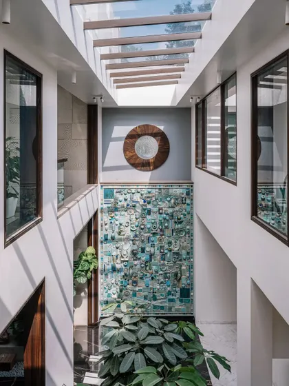 The full view of the ceramic mural from the upper level, showing how it dominates the courtyard space and acts as a central visual anchor for the entire home.