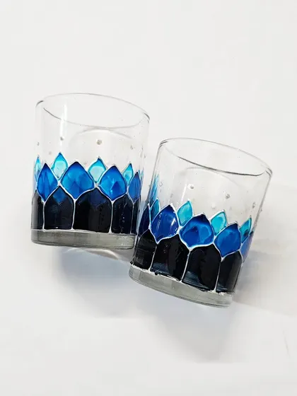 This pair of tea light holders is painted in shades of 'Curvy Indigo'. The deep and light blues blend together to create a cool, calming effect.