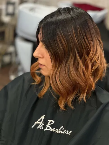 The beauty of warmth. This copper-toned ombre on a short, angled bob is a perfect example of a bold and stylish hair transformation.
