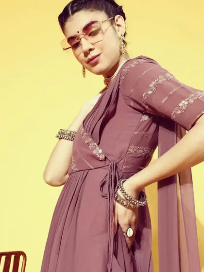 A closer look at the mauve saree-dress, showing the wrap-style bodice with a side tie-up and the delicate sequin detailing. It's a chic and comfortable option for any party.