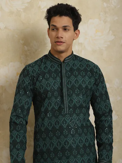 For summer occasion wear, I bring you this breezy, stylish dark green kurta pajama set. The detailed booti work makes it apt for any function or festival.