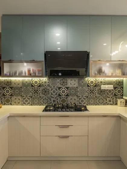The teal and cream kitchen is both vibrant and functional, with plenty of counter space and smart storage solutions.