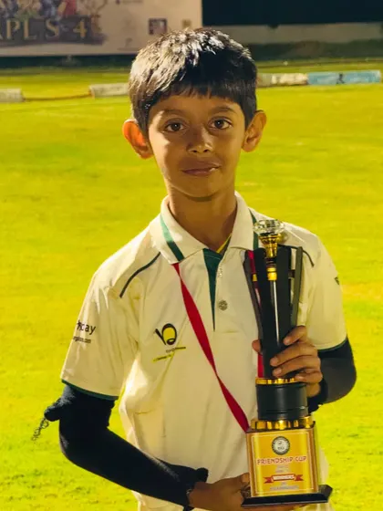 A young player holds his trophy, a symbol of his hard work and dedication.