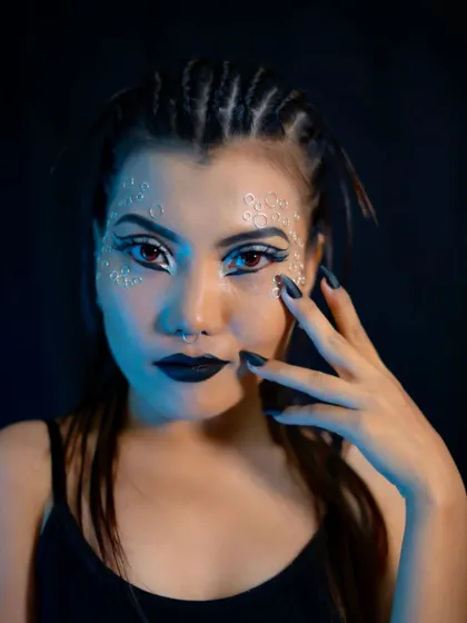 A bold catwalk makeup look featuring graphic white eyeliner and black lipstick. Our courses cover editorial and runway styles, teaching students how to create high-impact looks that stand out.