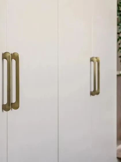 A close-up of the elegant brass handles on a custom wardrobe, showcasing my attention to the small details that elevate a design.