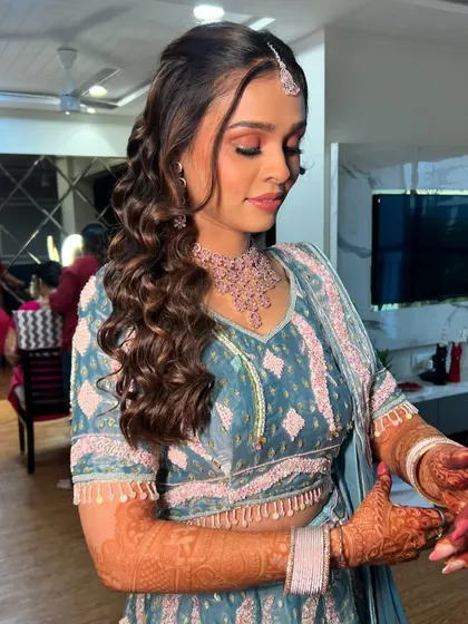 A candid moment of the bride getting ready, her hair and makeup looking perfect.