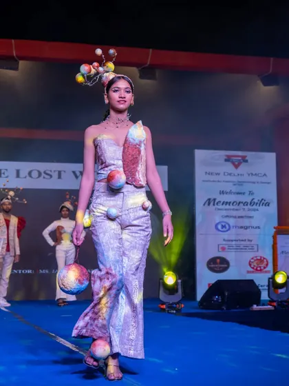 A whimsical, planet-themed outfit from the Memorabilia runway. This design highlights our students' ability to translate unconventional concepts into wearable art.