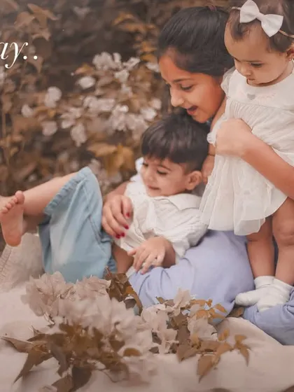 A playful and loving moment between three siblings nestled together on a blanket outdoors. These sessions are all about capturing their connection in a natural environment.