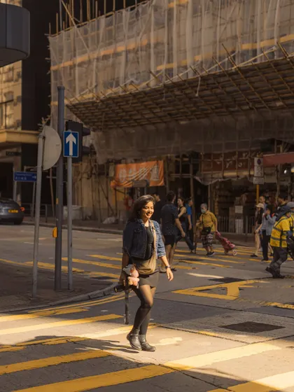 Walking through a sunbeam on a busy Hong Kong street. This image is a great example of how I use natural light to highlight the subject in my street and travel photography.