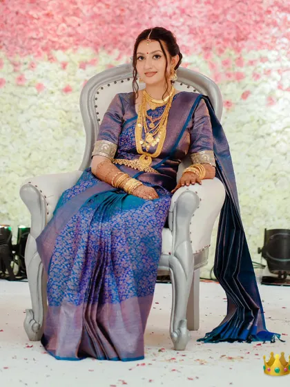 A regal portrait of Aparna for her Pheras. Dressed in a traditional South Indian silk saree, her makeup is classic and elegant, with a focus on defined eyes and gold jewelry.