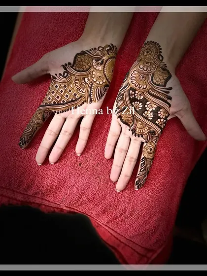 An elegant, asymmetrical design perfect for an engagement or sangeet. One hand features a geometric pattern, while the other has a more organic, flowing design, creating a modern and artistic look.