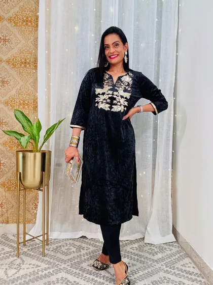 This black velvet kurta with silver and gold embroidery is a classic and timeless party wear option. It's sophisticated and glamorous.