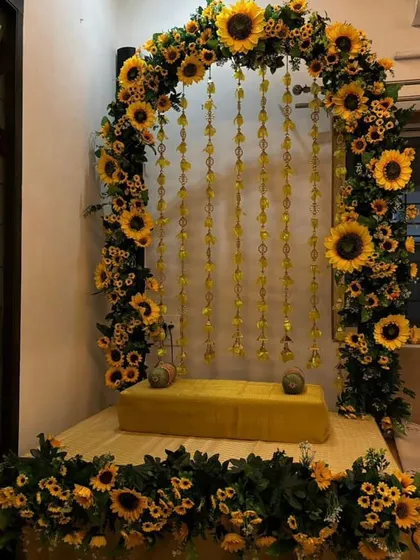 Sunflowers bring instant joy and warmth to any celebration. We created this unique Ganpati setup with a full arch of bright sunflowers and delicate hanging elements, perfect for a cheerful and modern festive theme.