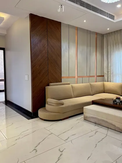 Another view of the Ghibli-inspired living room, highlighting the clean lines of the marble flooring and the subtle elegance of the wall treatments.