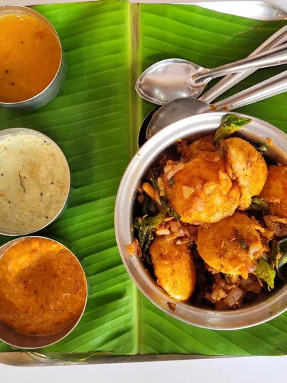 A customer's photo of our Podi Idly, served on a banana leaf with our signature chutneys. It's a spicy, flavorful dish that's a favorite for many.