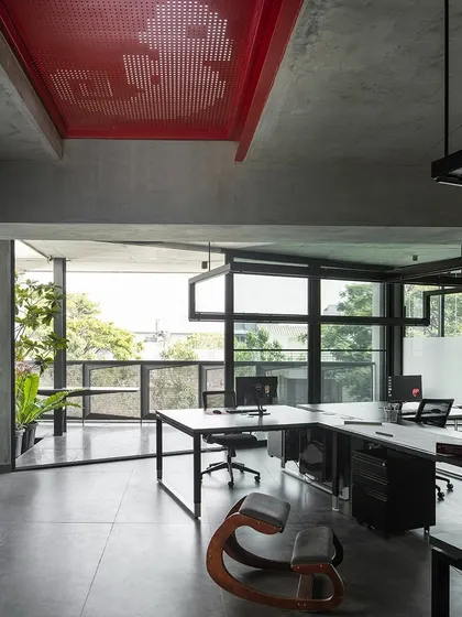 The main studio space in our office is designed for collaboration. Open-plan workstations are arranged to foster communication, while large windows provide ample natural light and views of the city. The red perforated steel ceiling adds a splash of color and visual interest.