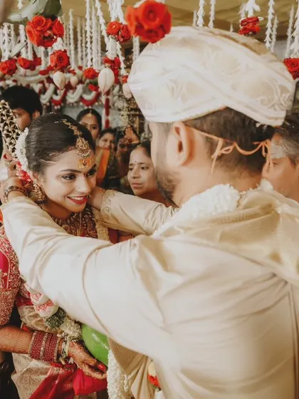 The groom tying the sacred thread, a pivotal and emotional moment of the wedding ceremony.