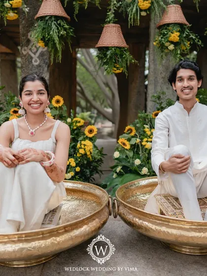 For this Haldi, we focused on a vibrant yellow theme with rustic touches. We used hanging cane baskets filled with yellow flowers, lush greens, and traditional brass urlis to create a warm and sunny celebration.