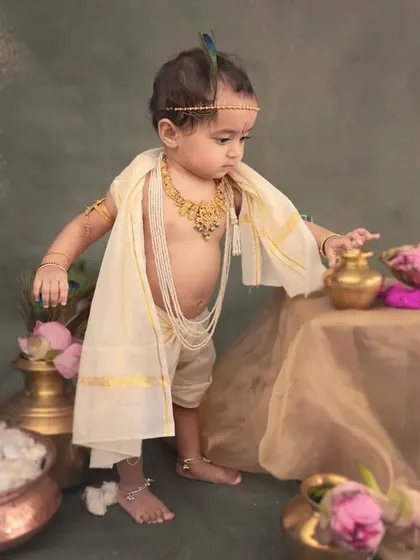A standing pose for a curious baby. He reaches for the props, giving us a dynamic and engaging portrait that captures his developing motor skills.