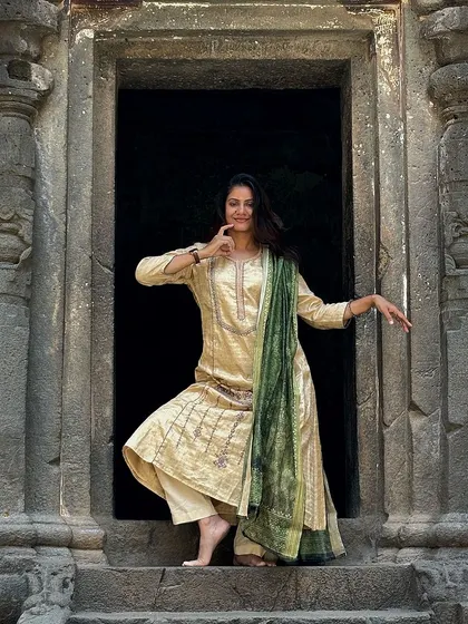 A playful pose at the entrance of a cave temple at Ellora. The architecture itself feels like a dance.